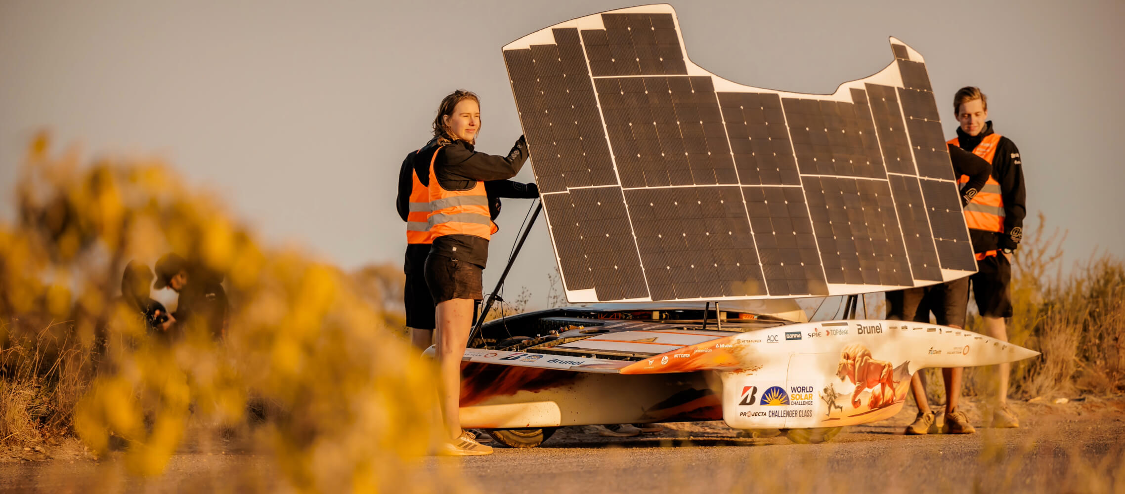 The Brunel Solar Team operating the solar panel of a car