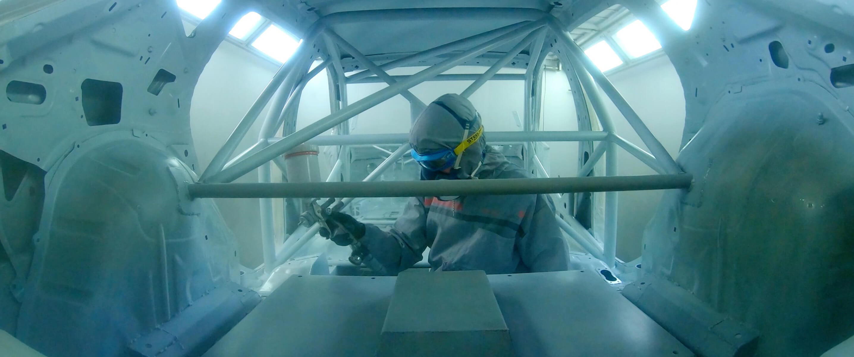 Worker spray painting the CUPRA e-Racer's interior roll cage