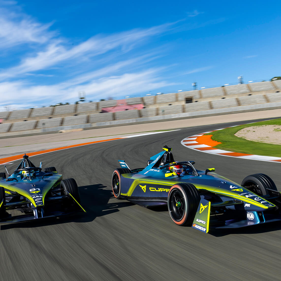 Two CUPRA Formula Es driving around a racetrack
