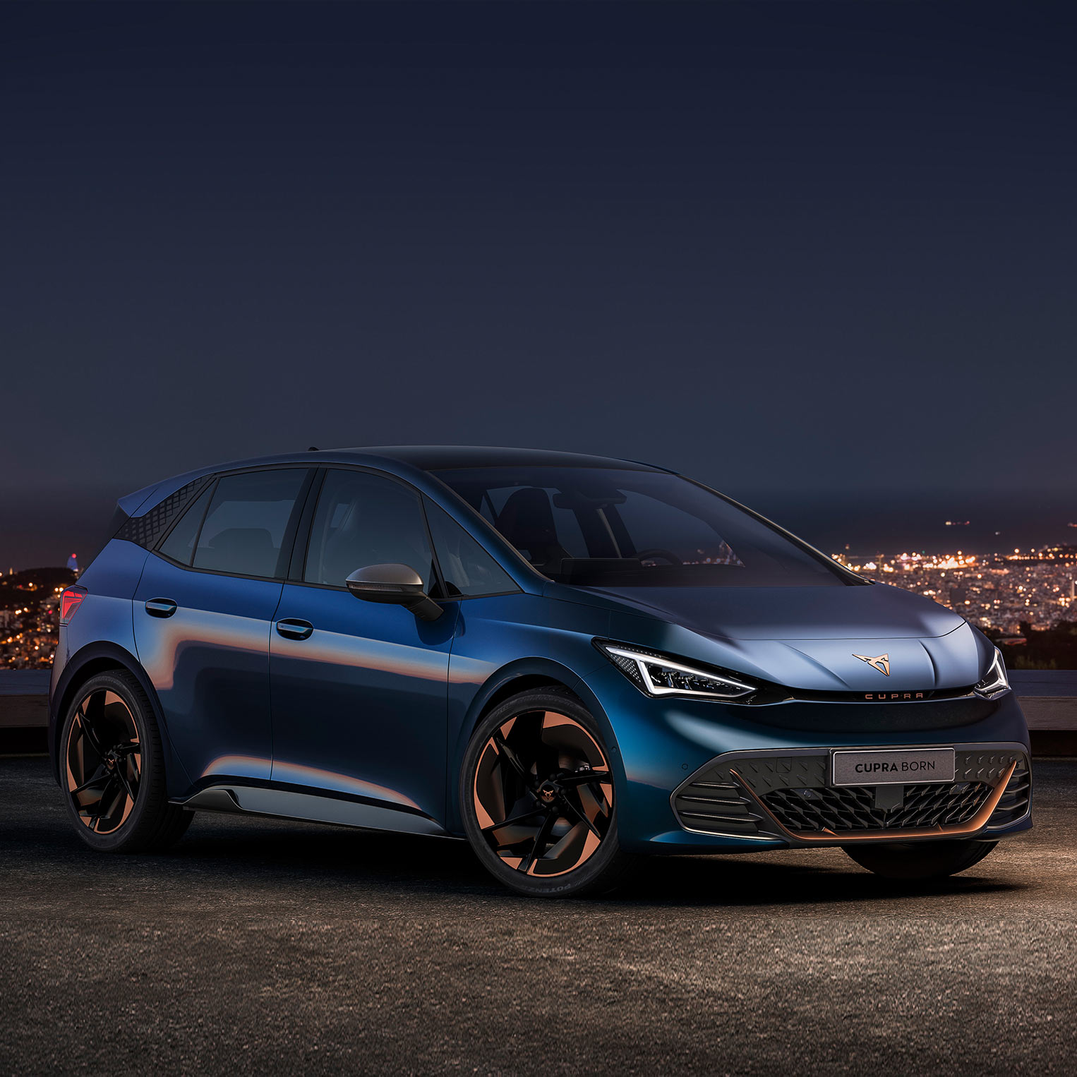A close-up of a CUPRA Born against a city background at night