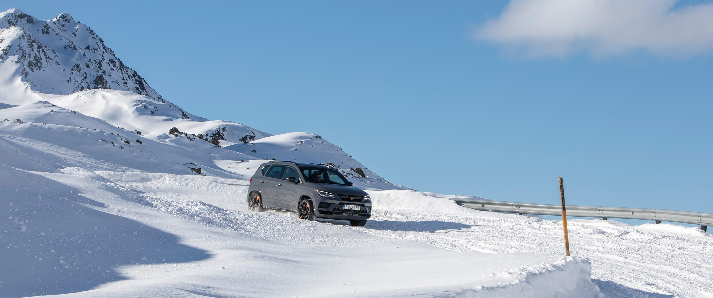 A CUPRA Ateca driving down a snowy mountainside
