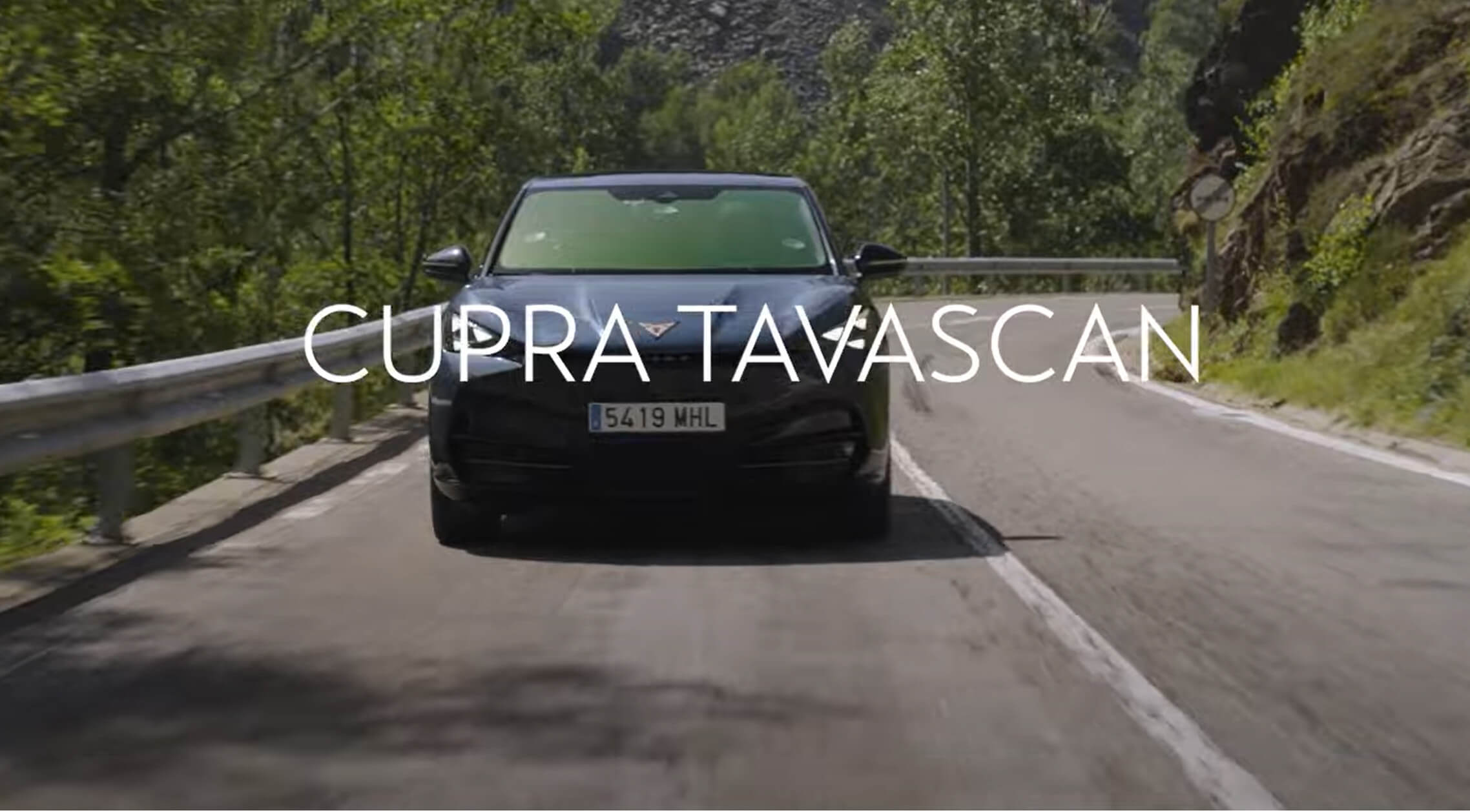 A CUPRA Tavascan driving on the road toward the camera