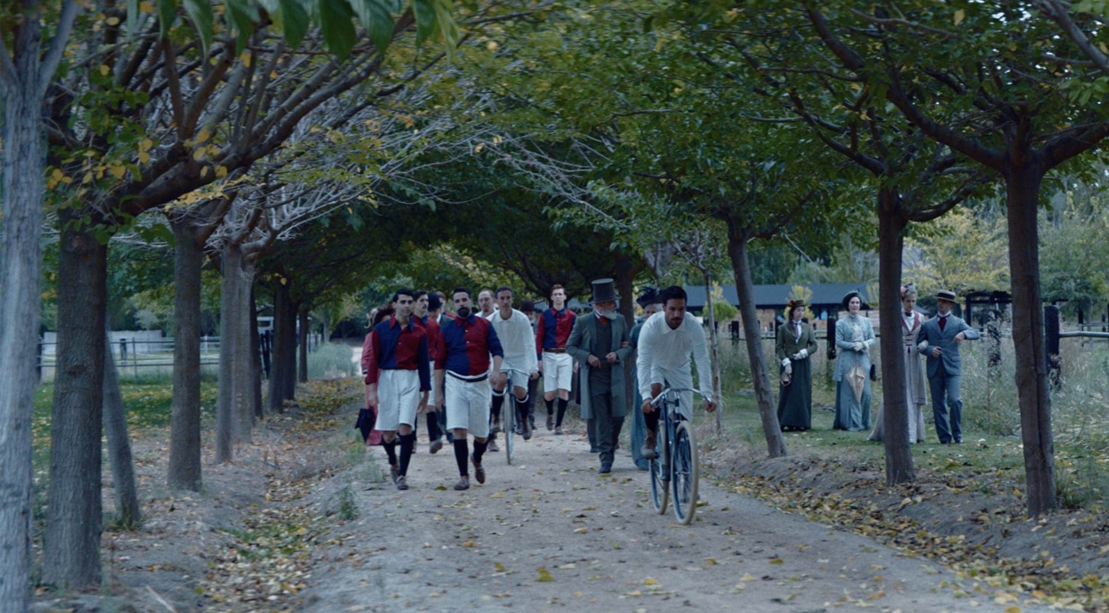 FC Barcelona players walking down a tree-lined path