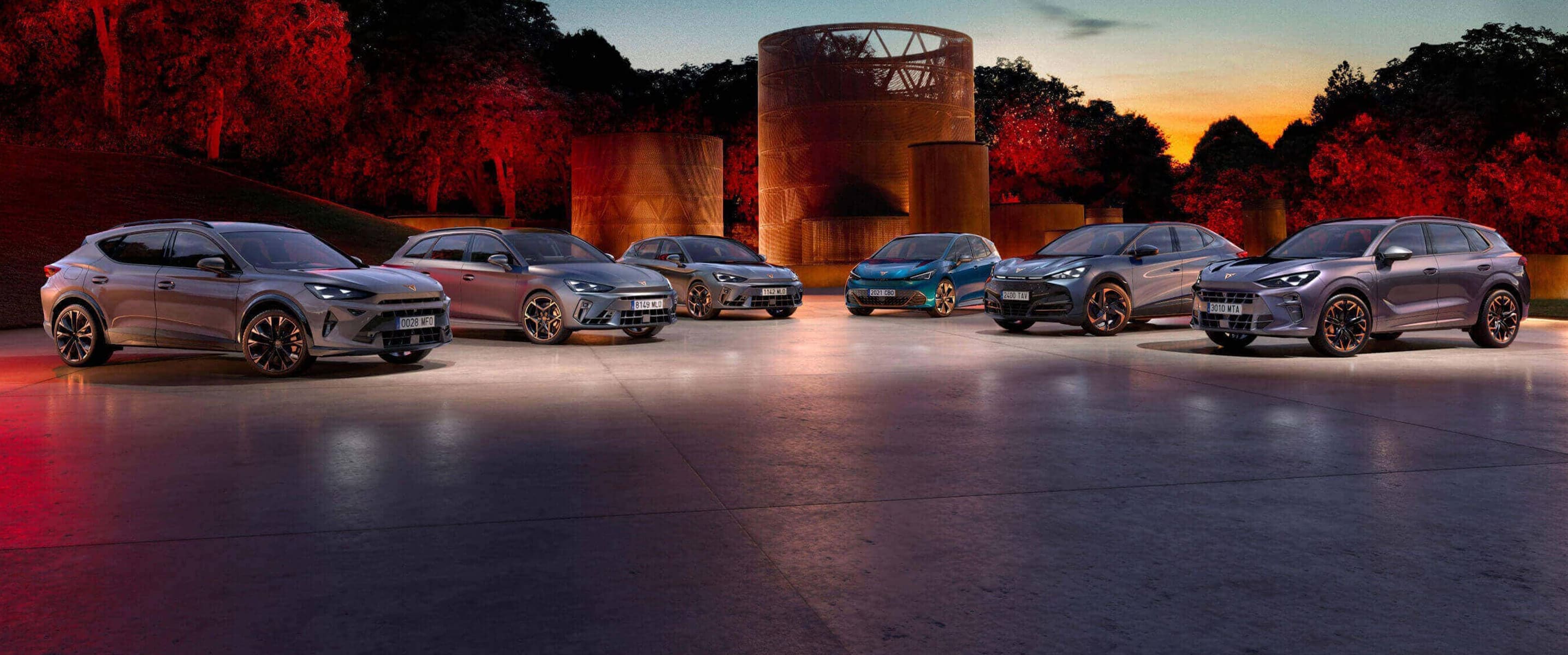 The CUPRA range at night with circular structures in the background