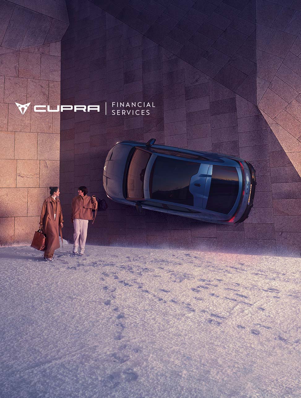 A couple walking away from a CUPRA Tavascan that is hanging on a wall