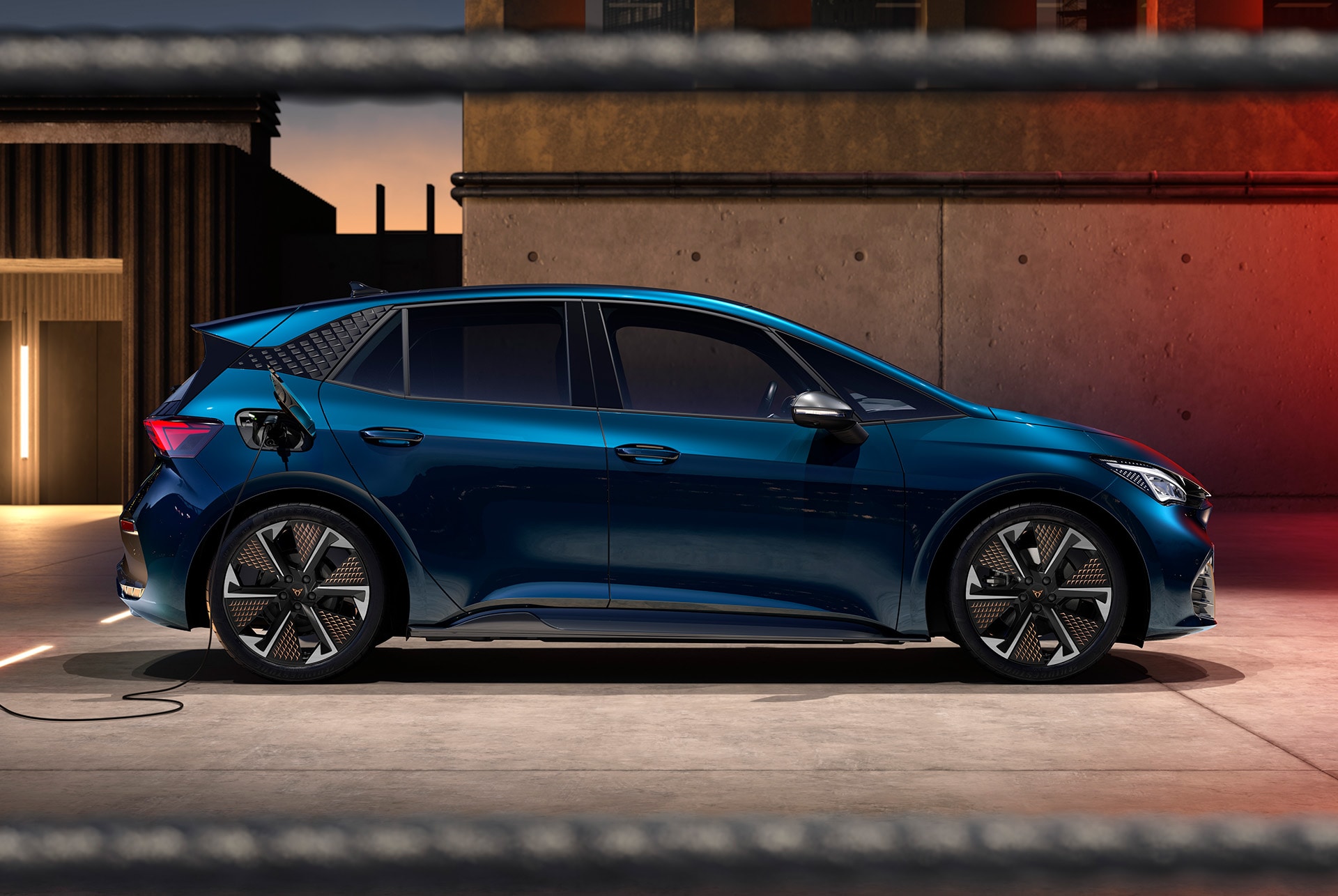 an electric blue CUPRA Born parked and charging