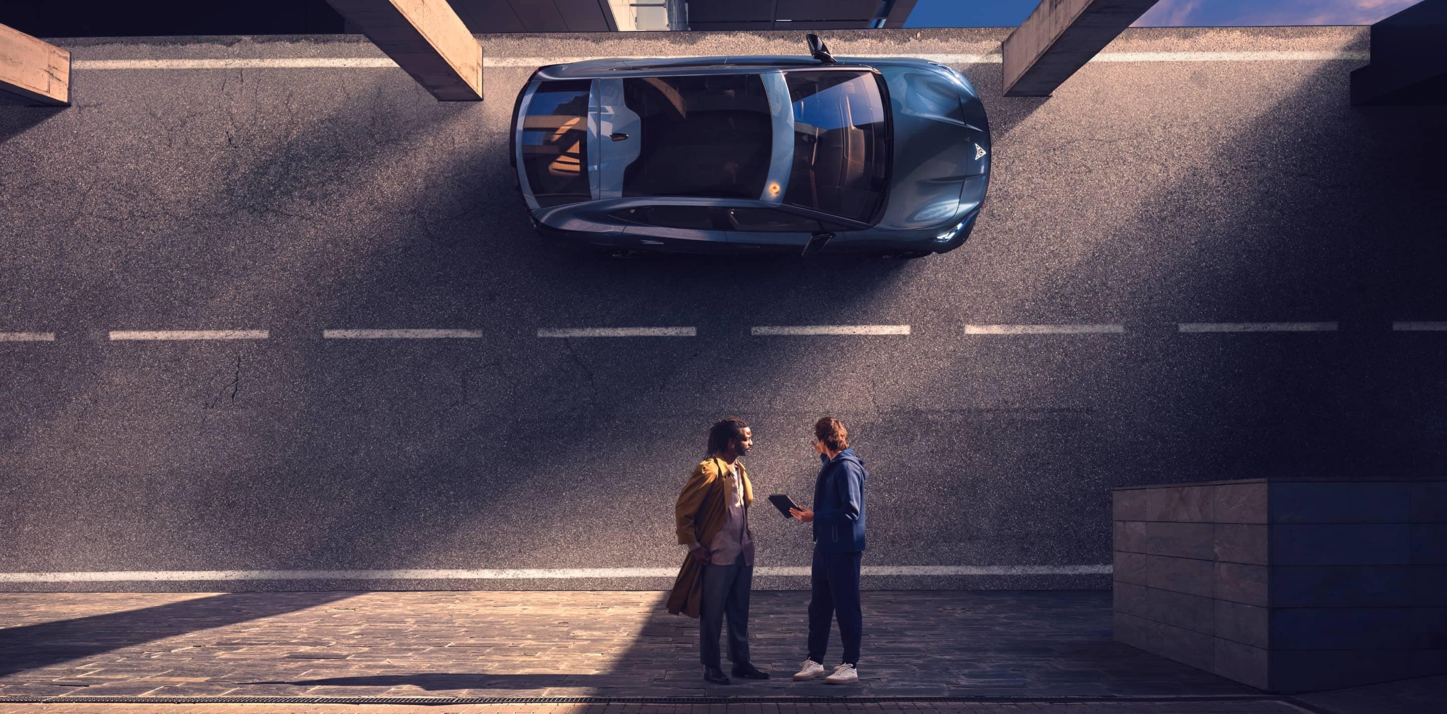 Overhead view of a cupra electric car parked on the street with two people standing and discussing benefits of hybrid and electric cars, financial advantages and incentives for choosing an electric or hybrid CUPRA vehicle.